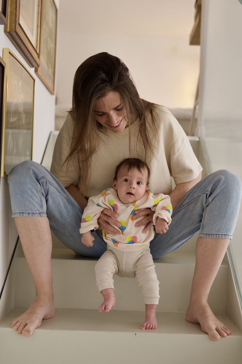 Mother and baby sitting together on the stairs