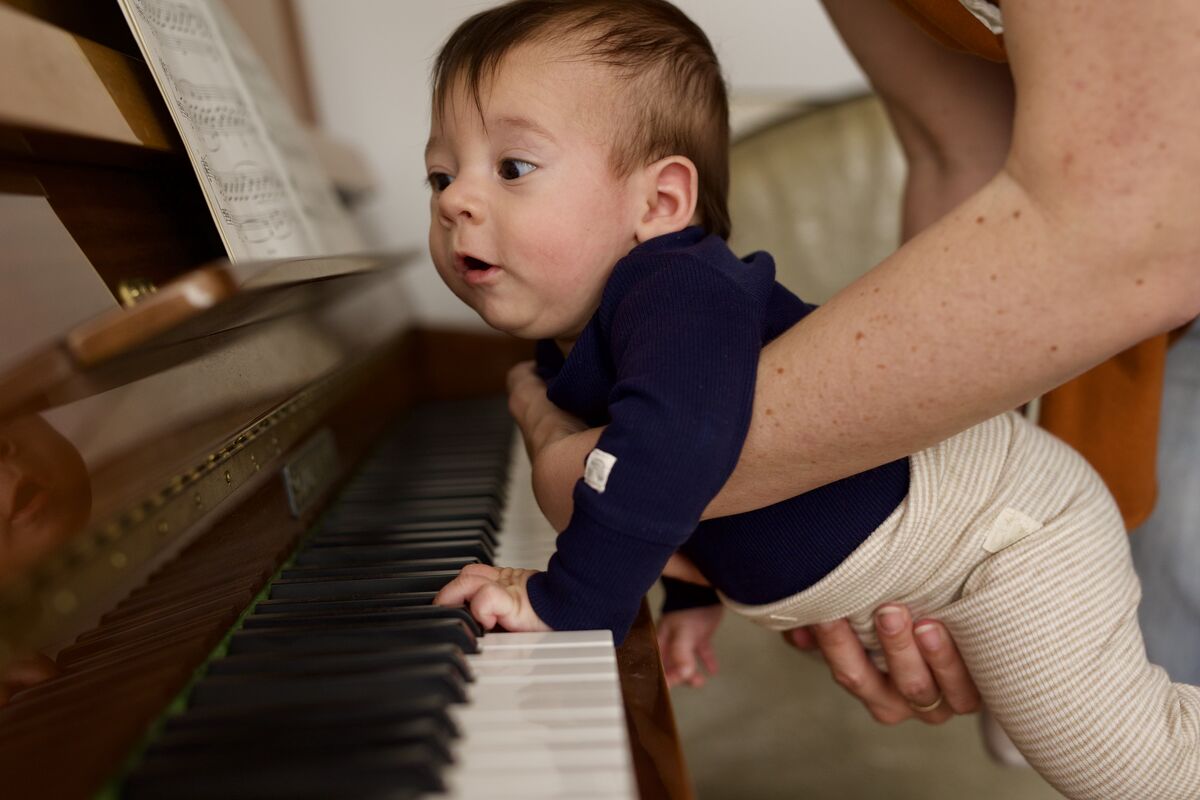 Baby reaching for piano keys