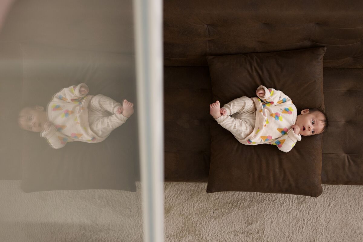 Baby lying on a cushion with a gentle reflection