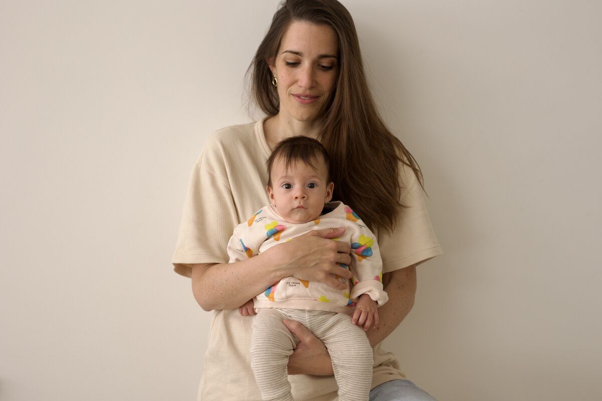 Mother cradling baby in a studio setting