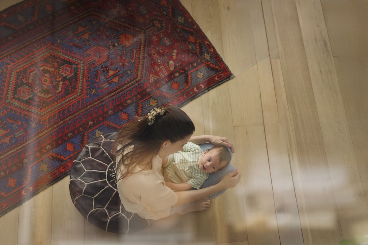 Overhead view of mother and baby on wooden floor